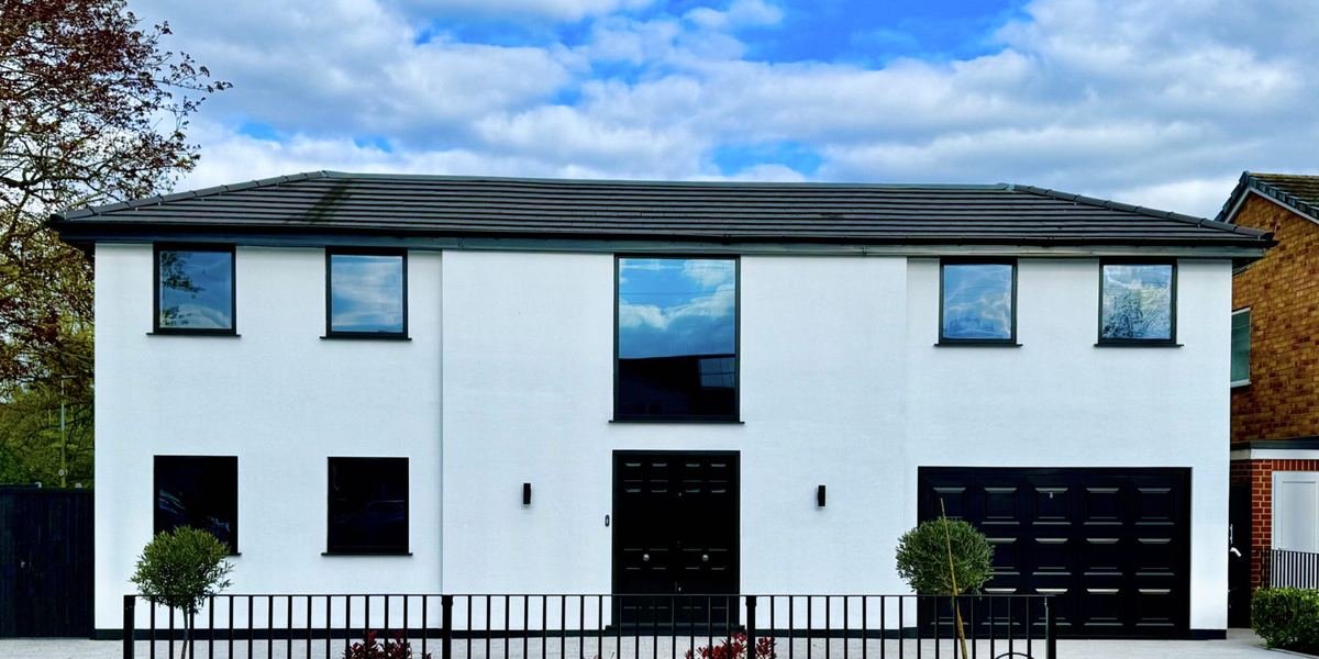 Completed modern house extension with rendered walls and large windows, built by HK Builders Ltd