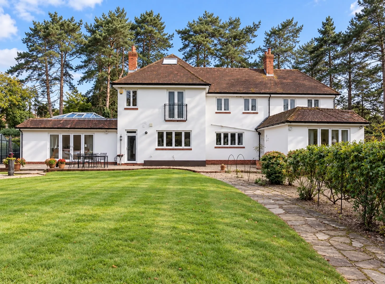 Rear of a detached house with a single storey rear extension and garden