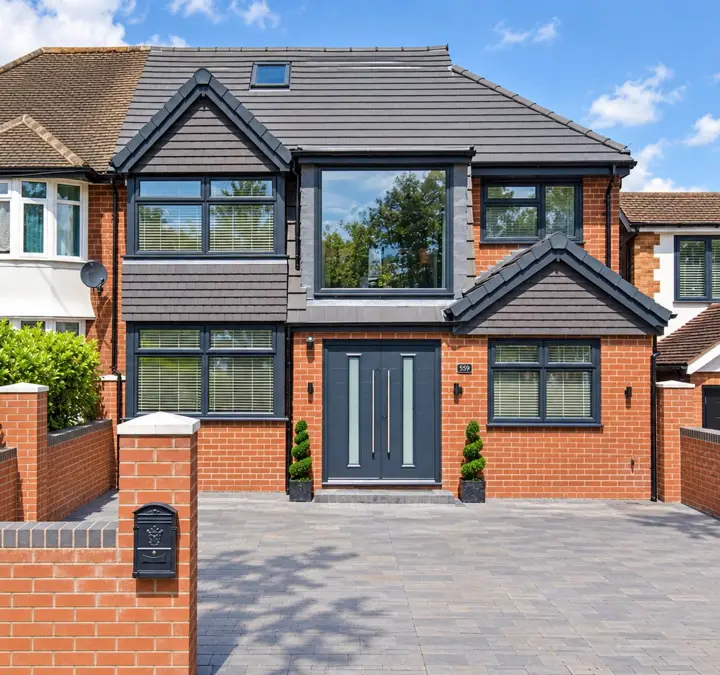 Semi-detached house with a large dormer extension and grey cladding