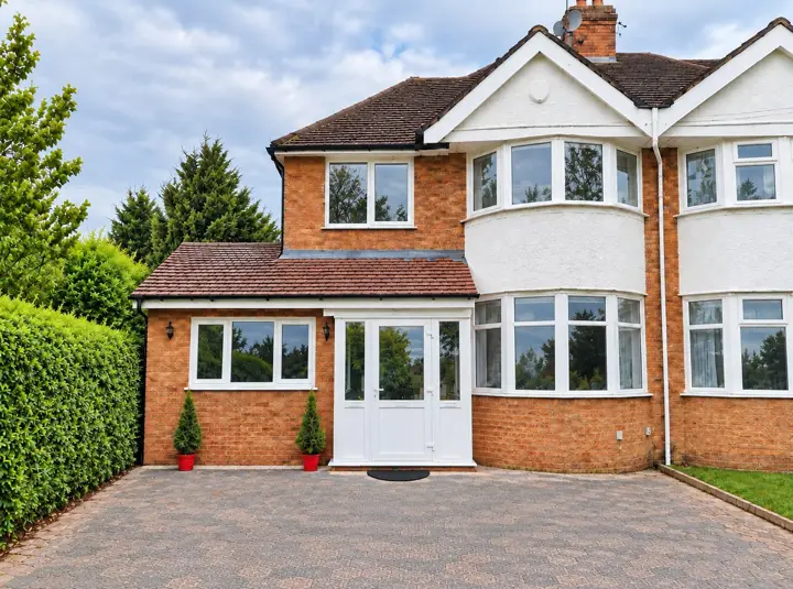 Semi-detached house with a front porch extension